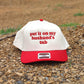 Funny embroidered trucker hat that says put it on my husband's tab with red embroidery and red bill

